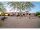 View of the front of a Southwestern-style home with desert landscaping at 8024 E Lone Mountain Rd, Scottsdale, AZ 85266