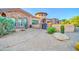 Beautiful home with stone accents, a circular tower, and lush desert landscaping at 8024 E Lone Mountain Rd, Scottsdale, AZ 85266