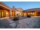 Charming home with stone accents, a graveled yard, and a tiled walkway leading to a private courtyard at 8024 E Lone Mountain Rd, Scottsdale, AZ 85266