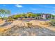 Gorgeous home boasting desert landscaping, a stone facade, and a circular tower at 8024 E Lone Mountain Rd, Scottsdale, AZ 85266