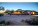 Expansive desert property featuring a custom home with unique architectural details and mature trees at 8024 E Lone Mountain Rd, Scottsdale, AZ 85266