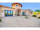 The luxurious home features a circular tower and large windows at 8024 E Lone Mountain Rd, Scottsdale, AZ 85266