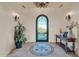 A grand foyer showcases a decorative tile floor, wrought iron door, and elegant lighting at 8024 E Lone Mountain Rd, Scottsdale, AZ 85266