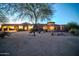 Expansive property with lush desert landscaping and a circular driveway, creating a grand entrance at 8024 E Lone Mountain Rd, Scottsdale, AZ 85266
