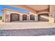 Attached garages with decorative doors and an arched portico at 8024 E Lone Mountain Rd, Scottsdale, AZ 85266