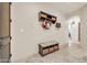 Hallway featuring bench with storage baskets, floral wreath, and open layout at 8024 E Lone Mountain Rd, Scottsdale, AZ 85266