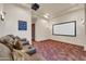 Home theater featuring leather seating, projector screen, and custom rug design at 8024 E Lone Mountain Rd, Scottsdale, AZ 85266