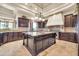Spacious kitchen with granite counters, a large island, and custom cabinets at 8024 E Lone Mountain Rd, Scottsdale, AZ 85266