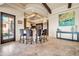 Breakfast bar area leading into a gourmet kitchen with granite counters and custom cabinets at 8024 E Lone Mountain Rd, Scottsdale, AZ 85266