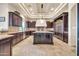 Gourmet kitchen with an island, stainless appliances, custom cabinetry, and granite counters at 8024 E Lone Mountain Rd, Scottsdale, AZ 85266