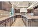 Gourmet kitchen with custom cabinets, stainless appliances, and a large island for entertaining at 8024 E Lone Mountain Rd, Scottsdale, AZ 85266