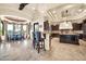 Gourmet kitchen and dining area with island, granite counters, bar seating, and high-end appliances at 8024 E Lone Mountain Rd, Scottsdale, AZ 85266