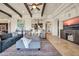 Spacious living room featuring travertine floors, exposed beams, and an open layout to the wet bar at 8024 E Lone Mountain Rd, Scottsdale, AZ 85266