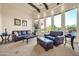 Bright living room with large windows, beamed ceilings, and stylish leather seating at 8024 E Lone Mountain Rd, Scottsdale, AZ 85266