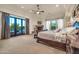 A luxurious main bedroom with a fireplace, lounge area, and view of the outside at 8024 E Lone Mountain Rd, Scottsdale, AZ 85266