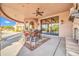 Covered outdoor living space featuring travertine flooring and a ceiling fan at 8024 E Lone Mountain Rd, Scottsdale, AZ 85266