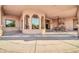 A spacious outdoor area featuring travertine flooring, a fireplace, and a covered patio at 8024 E Lone Mountain Rd, Scottsdale, AZ 85266