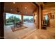 Covered patio with dining set, ceiling fan, and seamless indoor-outdoor flow, perfect for entertaining guests at 8024 E Lone Mountain Rd, Scottsdale, AZ 85266