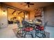 Outdoor dining space with a stone fireplace, offering a seamless transition to the indoor living area through large sliding doors at 8024 E Lone Mountain Rd, Scottsdale, AZ 85266