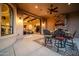 Inviting outdoor dining area with a stone fireplace, seamlessly connected to the interior through sliding glass doors at 8024 E Lone Mountain Rd, Scottsdale, AZ 85266