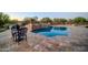 Backyard pool with stone accents, raised spa, and desert landscaping at 8024 E Lone Mountain Rd, Scottsdale, AZ 85266
