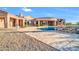 A backyard with travertine decking that features a pool, spa, and landscaping at 8024 E Lone Mountain Rd, Scottsdale, AZ 85266