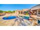 Backyard pool and patio area with travertine decking and desert landscaping at 8024 E Lone Mountain Rd, Scottsdale, AZ 85266