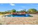 Backyard pool featuring a stone deck, a stone waterfall, and desert landscaping at 8024 E Lone Mountain Rd, Scottsdale, AZ 85266
