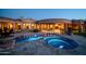 Backyard oasis featuring a sparkling pool and spa, surrounded by elegant stone and lush landscaping at 8024 E Lone Mountain Rd, Scottsdale, AZ 85266