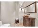 Elegant powder room with a custom vanity, unique sink, and decorative lighting at 8024 E Lone Mountain Rd, Scottsdale, AZ 85266
