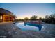 Resort-style backyard showcasing a sparkling pool, stone accents, and serene desert views at 8024 E Lone Mountain Rd, Scottsdale, AZ 85266