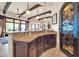 Elegant wet bar featuring granite countertops, custom cabinetry, and decorative wrought iron doorway at 8024 E Lone Mountain Rd, Scottsdale, AZ 85266