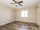 Bright bedroom with wood-look floors, a ceiling fan, and neutral paint at 9622 N 35Th Ln, Phoenix, AZ 85051