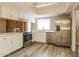 Modern kitchen features white cabinets, stainless steel appliances, and wood-look floors at 9622 N 35Th Ln, Phoenix, AZ 85051