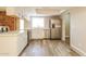 Modern kitchen features white cabinets, stainless steel appliances, and wood-look floors at 9622 N 35Th Ln, Phoenix, AZ 85051
