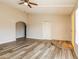 Spacious living room featuring wood-look floors, ceiling fan and arched doorway at 9622 N 35Th Ln, Phoenix, AZ 85051