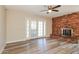 Open living room features a brick fireplace, wood-look floors and French doors at 9622 N 35Th Ln, Phoenix, AZ 85051