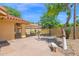 Inviting backyard featuring a covered patio, fountain, and lush landscaping, perfect for outdoor entertaining at 9797 N 100Th Pl, Scottsdale, AZ 85258