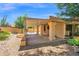 Charming backyard featuring a covered patio, fire pit, and desert landscaping at 9797 N 100Th Pl, Scottsdale, AZ 85258