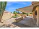 Beautiful backyard featuring a covered patio with desert landscaping, fountain, and mature trees at 9797 N 100Th Pl, Scottsdale, AZ 85258