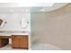 Bright bathroom featuring double vanity, round mirror, and glass enclosed shower with modern fixtures at 9797 N 100Th Pl, Scottsdale, AZ 85258