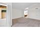 Large bedroom with plush carpeting, natural light, and a view into the ensuite bathroom space at 9797 N 100Th Pl, Scottsdale, AZ 85258