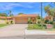 Inviting single-story home featuring a well-manicured lawn and a classic two-car garage, with a terra cotta colored roof at 9797 N 100Th Pl, Scottsdale, AZ 85258