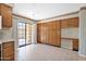Bright, eat-in kitchen has tile floors, wood cabinets, built-in desk, and access to a private outdoor patio at 9797 N 100Th Pl, Scottsdale, AZ 85258