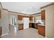 Charming kitchen with tile floors, wood cabinetry, and a window offering scenic views to the outdoor space at 9797 N 100Th Pl, Scottsdale, AZ 85258
