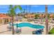 An elevated view of the community pool, with lounge seating, shade umbrellas and palm trees surrounding the pool at 9797 N 100Th Pl, Scottsdale, AZ 85258