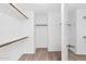 Spacious walk-in closet offering ample storage and organization with multiple shelves and rods at 9797 N 100Th Pl, Scottsdale, AZ 85258