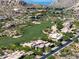 Scenic aerial view of homes in a golf community, with desert landscaping and mountain views at 10641 E Blue Sky Dr, Scottsdale, AZ 85262