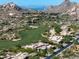 Scenic aerial view of homes in a golf community, with desert landscaping and mountain views at 10641 E Blue Sky Dr, Scottsdale, AZ 85262