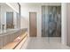 Stylish bathroom featuring a double sink vanity, a sleek glass-enclosed shower, and modern fixtures, creating a spa-like retreat at 10641 E Blue Sky Dr, Scottsdale, AZ 85262